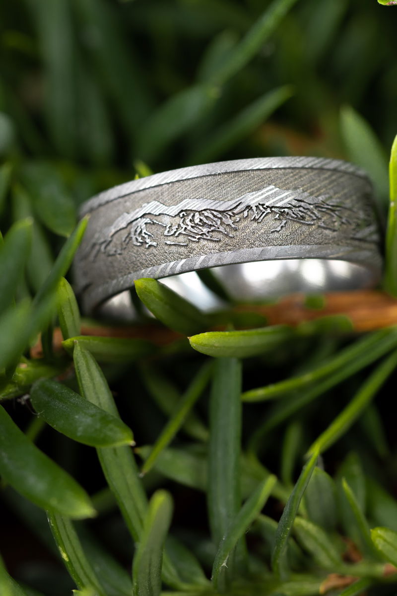 A Damascus band engraved with a mountain range