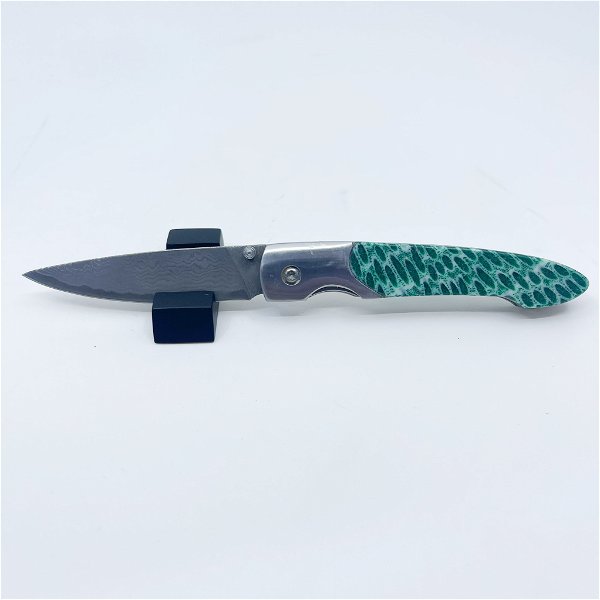 Closeup photo of Dyed Coral Fossil Folding Knife