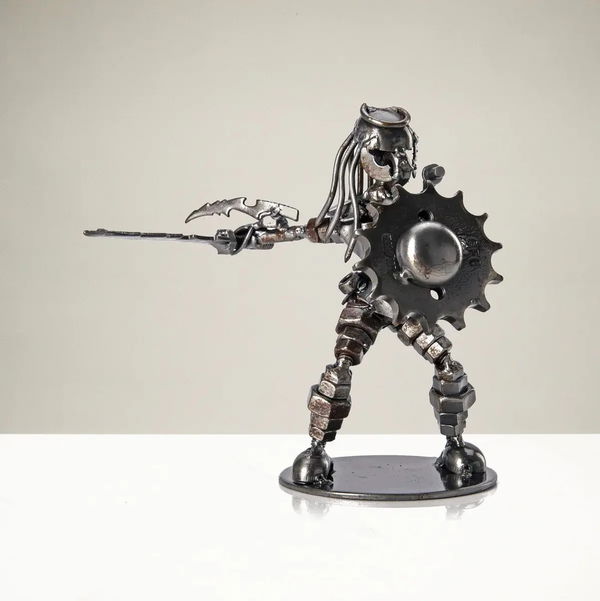 Closeup photo of Predator with Sword and Shield Inspired Recycled Metal Sculpture