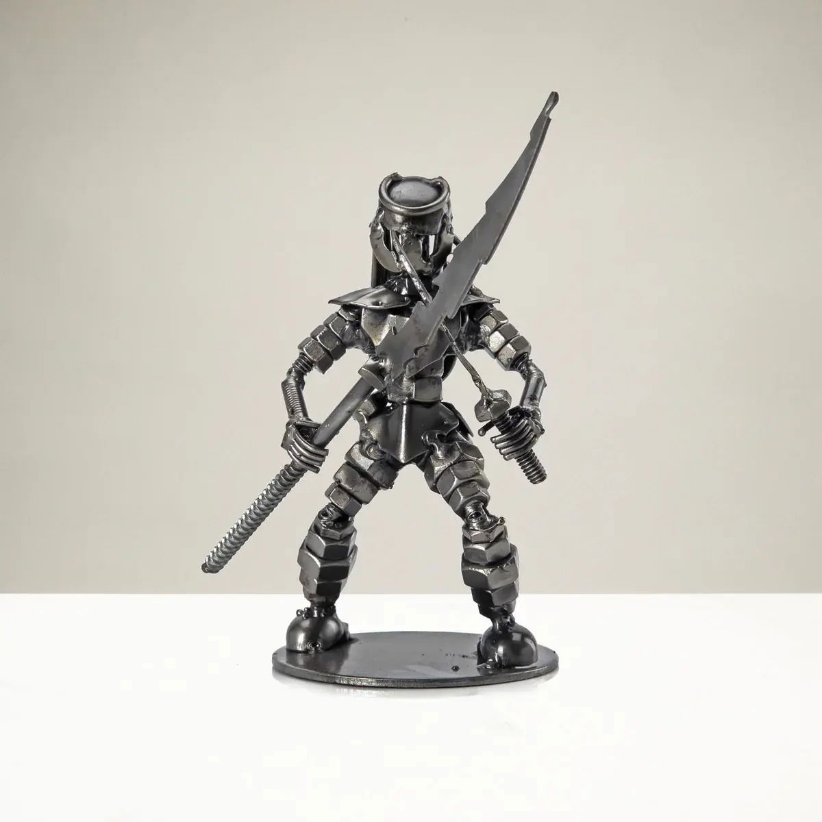 Dual Wielding Predator with Spear Inspired Recycled Metal Sculpture