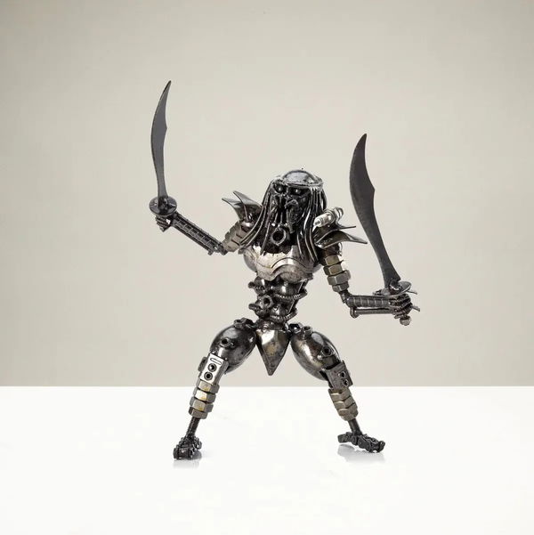 Closeup photo of Predator with Dual Wielded Sword Inspired Recycled Metal Sculpture