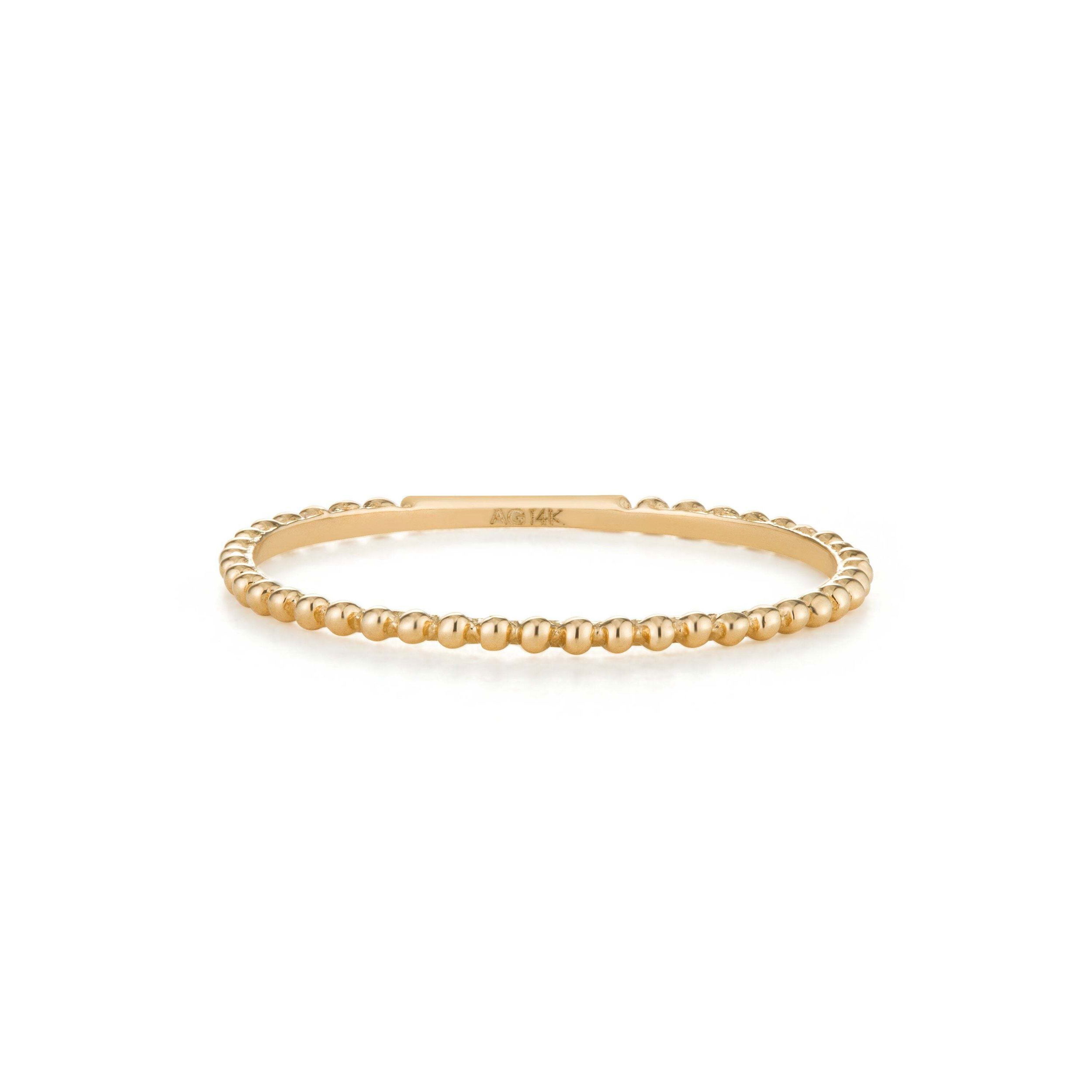 Our Connie Stacking Dots Band is the perfect addition to your ring collection. Wear this simple yet special style stacked with your diamond band for a edgy effect.. Material: 14K Solid GoldSize Specification: #5, #6, #7, #8Band Thickness: 0.8mmBead Diameter: 0.9mm CONNIE | Stacking Dots Band