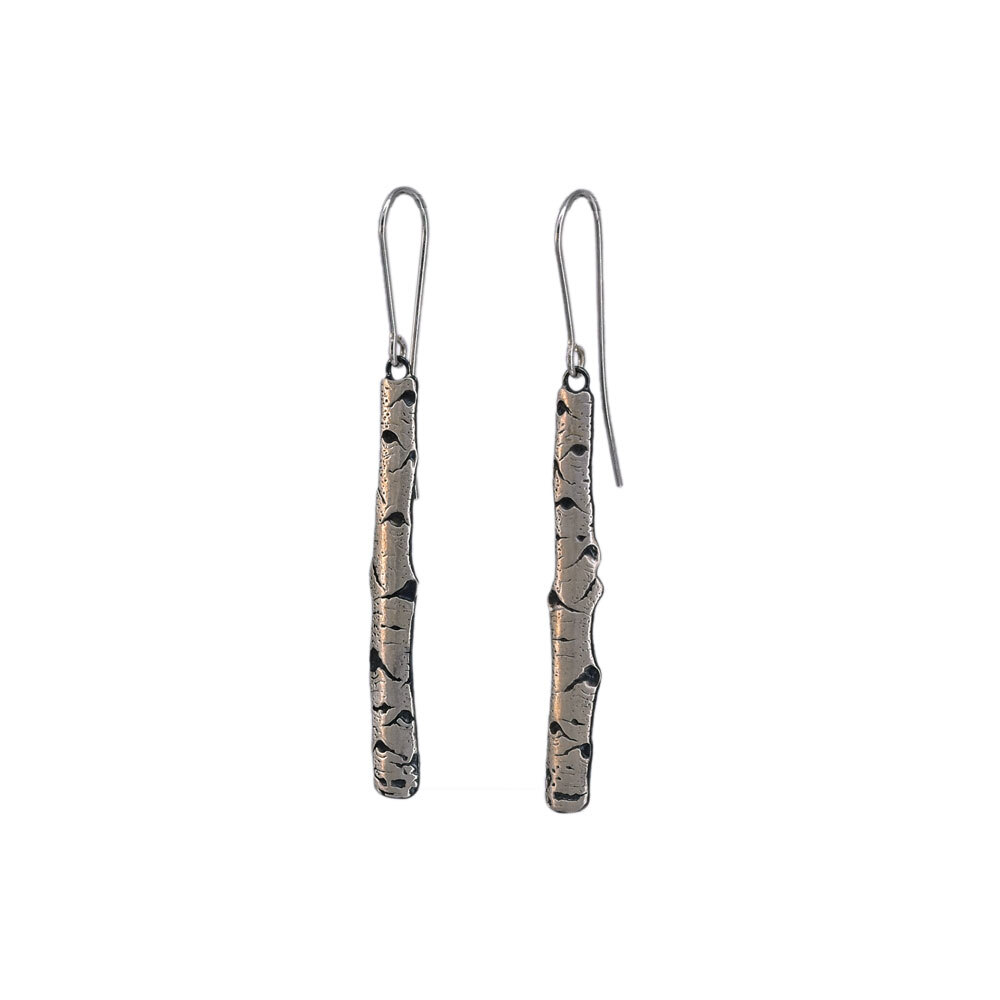 Simplicity is beauty! These Aspen bark earrings have been carefully rendered to capture the eye-shaped markings indicative of these trees. Inspired by Aspens of the Rockies, the artist has chosen to highlight the individual trees thereby giving us a more intimate view of this amazing species. Aspen Allure Bark Sterling Silver Earrings .2” x 1 3/4”