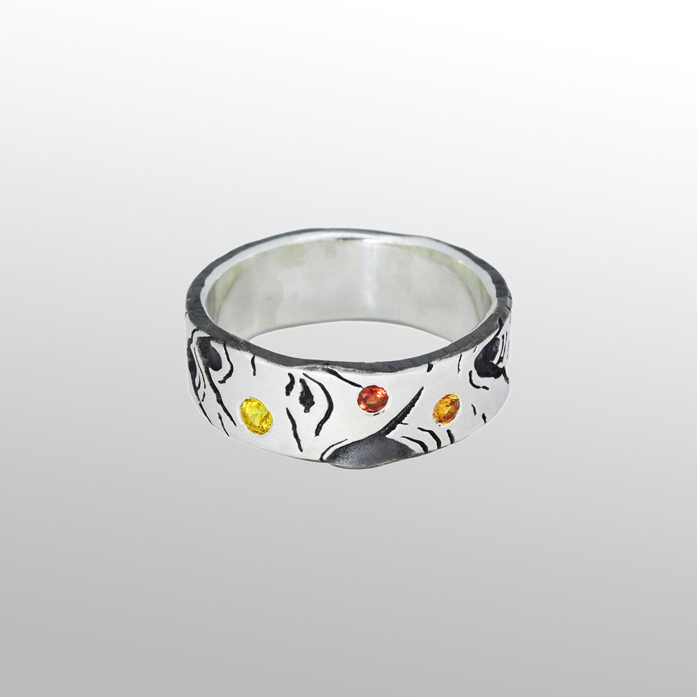Symbols of resilience, longevity and ample beauty, Aspens are a revered tree in the Rockies. Natural markings coupled with sapphire highlights are the inspiration for a finely crafted ring. Specific sizes are available by special order. Aspen Allure With Sapphires Silver Band Ring