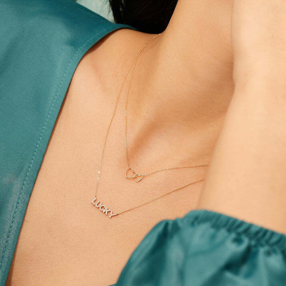 This design is inspired by the everlasting bond of love and friendship and makes for the sweetest gift. Crafted in polished 14kt gold, this updated classic symbolizes that special, eternal connection.Product Details:Material: 14K Solid GoldChain Type: Cable Chain 0.7mm thicknessChain Length: 16 inchesExtension chain: 2 inchesBigger Heart Size: 8*7.5mmSmaller Heart Size: 6*5.7mm JUlLIETTE | Interlocked Hearts Necklace