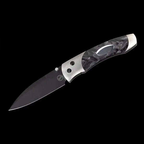 Closeup photo of Titanium pocketknife with compressed black acrylic resin and stainless blade