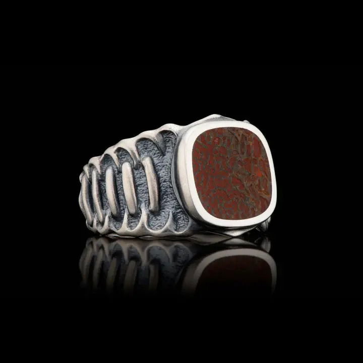 Step up to a higher Echelon with this exquisite piece from William Henry. The body is beautifully sculpted in Sterling Silver, with a side pattern inspired by the fine tradition of Celtic knots. The outside is lightly oxidized and soft finished to showcase the detail, and the inside is mirror polished to a ‘comfort fit’. Select your favorite inlay choice from our hallmark gem-grade materials. Timeless elegance, designed and built for every lifestyle. Echelon Dinosaur Bone Inlay Ring