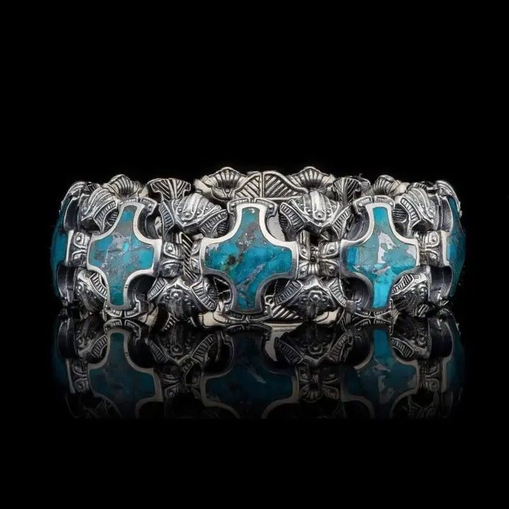 The 'Ithica' features heavy sculpted sterling silver links inlaid with zinc infused Kingman Turquoise. This stunning material displays a beautiful contrast between the soft blues of the Turquoise and the contemporary sharpness of the zinc. This fine piece of William Henry jewelry has been finished with our stainless button lock clasp and set with a genuine white topaz. Ithica Turquoise Bracelet