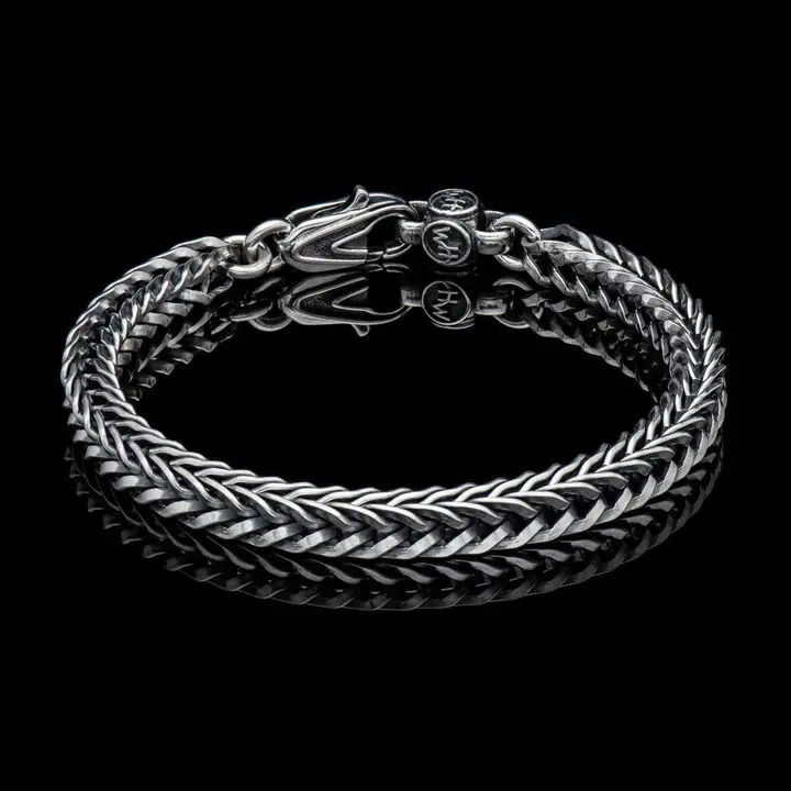 Bold, supple, fluid, snakelike, this foxtail chain in sterling silver is in a league of its own. Beautifully oxidized and hand polished, this complex pattern flows around the wrist and draws the eye closer. There are a great many foxtail pattern chains out there, but precious few that rise to the level of art on their own. Finished with our custom lobster clasp and available in a variety of sizes. Silver Link Bracelet