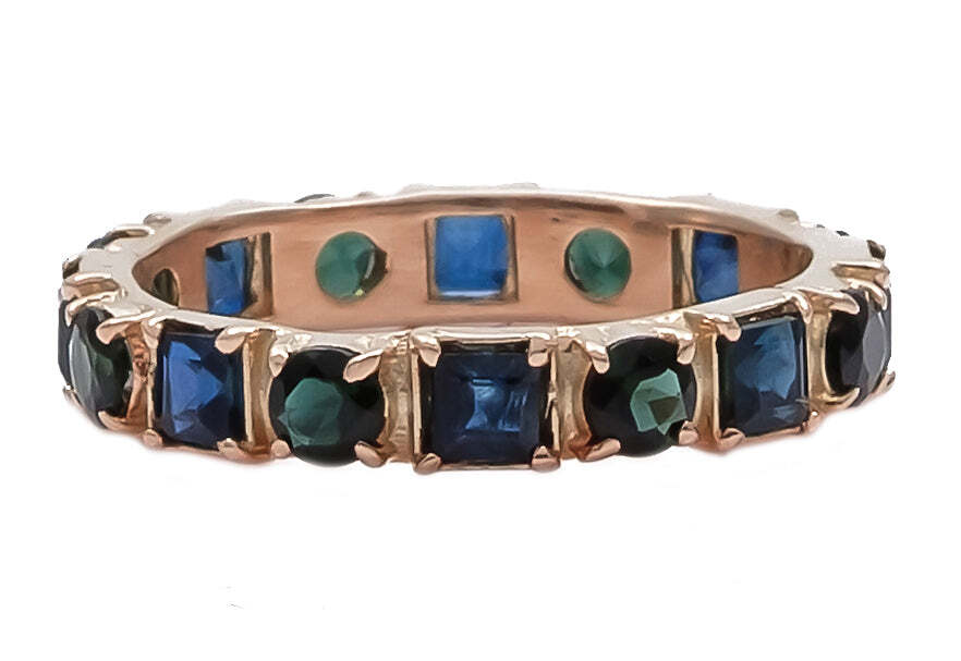 This exquisite 14k rose gold stack band features alternating square blue sapphires and round blue-green tourmaline gems, set in a shiny polished setting. These dazzling stones add a touch of glamour to any look, while the elegant rose gold band provides understated refinement. Wear alone or stacked with other bands of your choice for a look that is truly unique. The perfect blend of classic and modern design, this chic stack band is sure to be a cherished addition to any jewelry collection. Multi-Stone Stack Band Ring