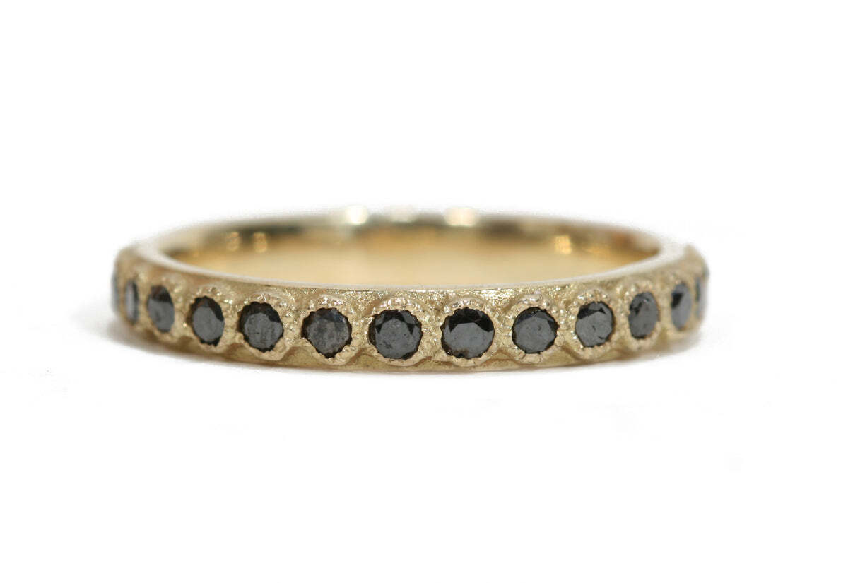 Add a modern touch to any look with this stunning 18K yellow gold black diamond stack ring. The sleek design of this exquisite ring features 0.68 TCW of glimmering black diamonds, giving it an eye-catching sparkle that's sure to turn heads. The warm hue of the yellow gold is the perfect complement for the black diamonds, making this ring a versatile accessory that can be worn with both casual and formal attire. Whether you're treating yourself or someone special to a luxurious ring, this black diamond stack ring is sure to be cherished for years to come. Diamond Stack Band Ring