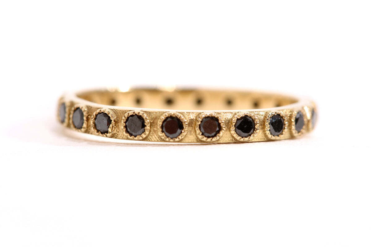 This 18K yellow gold black diamond stack ring is the perfect accessory to finish off any look. Featuring 0.50 carats of black diamonds, this gorgeous ring is sure to garner compliments. It has a band width of 0.09" (2.33mm) for extra flair, making it the perfect addition to any jewelry collection. Its striking beauty adds the perfect touch of elegance, making it an essential piece for any jewelry lover. Diamond Stack Band Ring