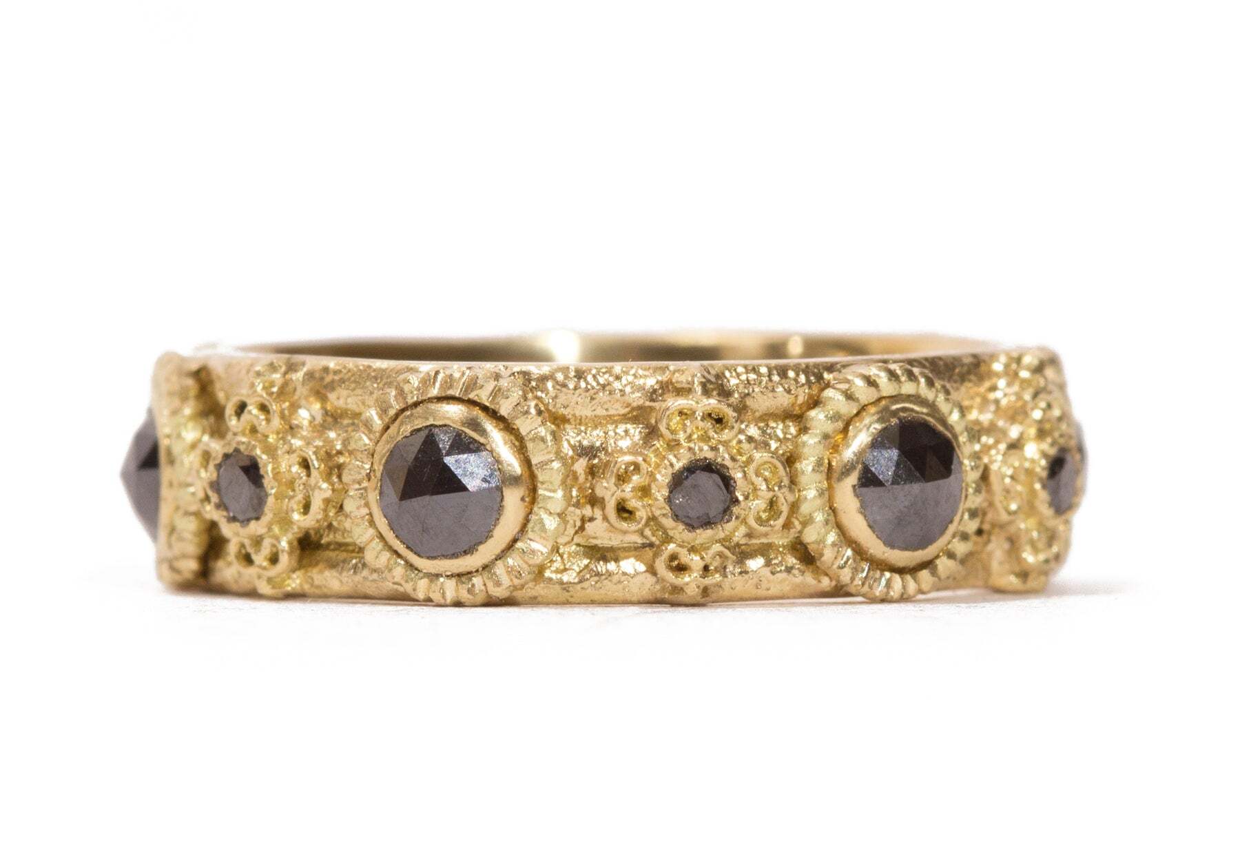 This exquisite 18K yellow gold wide band ring is sure to instantly become your new favorite. It sparkles with 0.90 carats of round and rose-cut black diamonds. The black diamonds contrast beautifully with the warm gold, making this modern piece a timeless treasure. Combining classic elegance with a chic contemporary look, this piece of fine jewelry is a must-have for any jewelry collection. Rose Cut Stack Band Ring