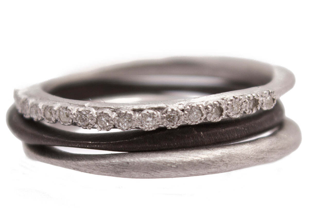 This stunning set of three stack rings will have you feeling like royalty every time you put them on. Crafted with sterling silver and blackened sterling silver, the set includes two silver finish bands and one pave band with white diamonds (0.08 TCW). Perfect for everyday wearing or special occasions, these stack rings will become your favorite accessory in no time. Set of 3 Stack Band Rings