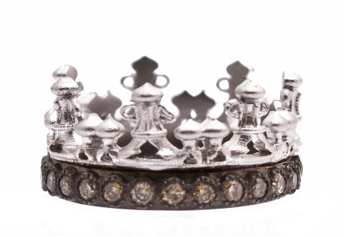 This beautiful and unique piece of jewelry features both blackened sterling silver and sterling silver paired with champagne diamonds. The perfect combination of classic and modern, this jewelry piece is sure to be an eye-catching addition to any outfit. With a total carat weight of 0.62, the champagne diamonds are sure to catch the light with their warm color and elegant sparkle. This delicate piece is perfect for any special occasion and would make a stunning and thoughtful gift. Crown Stack Band Ring