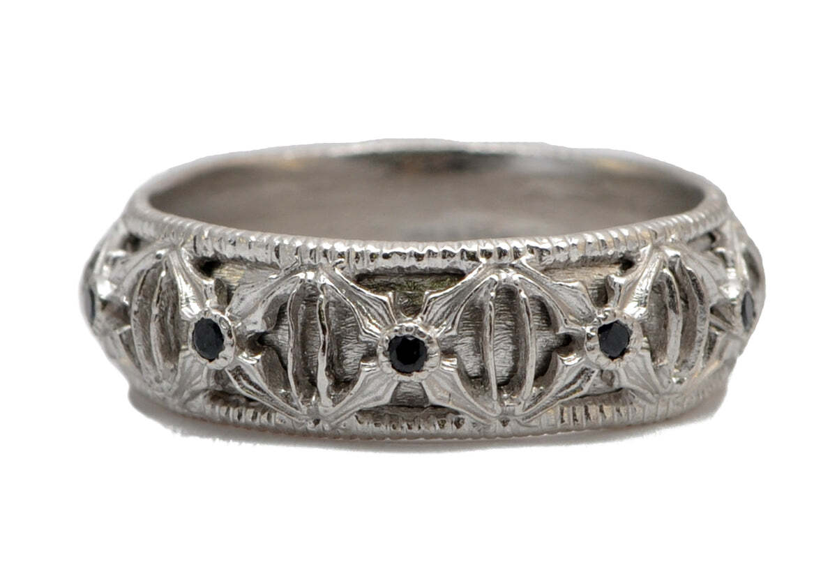 This stunning and unique Sterling Silver "X" Detailed Band with Black Sapphires is a must-have for any jewelry collection. Expertly crafted from premium Sterling Silver, this elegant band features a distinct crisscross pattern detailed with genuine Black Sapphires. The intricate design and enchanting sparkle of these gems make this piece an eye-catching statement piece or simply a beautiful accent. The perfect gift for any special occasion, this Silver band is sure to be treasured for generations. "X" Detail Wide Band Ring