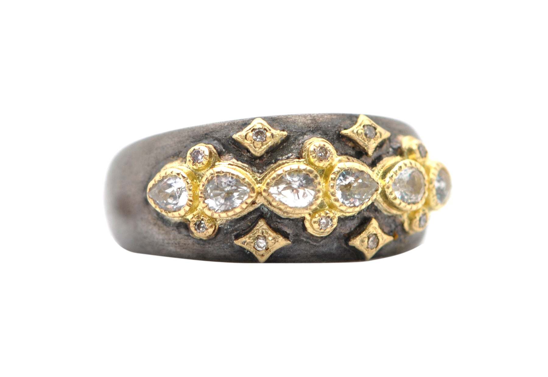 This gorgeous 18K yellow gold and blackened sterling silver lacy stack band ring with pear shaped white sapphires and champagne diamonds is a unique and eye-catching piece of jewelry. The combination of the yellow gold and the dark sterling silver creates a stunning contrast and the pear shaped white sapphires and champagne diamonds (0.05 TCW) add a touch of glamour. The top band measures 0.36" (9.38mm) in width and the bottom band measures 0.15" (3.95mm) in width, making it perfect for everyday wear. With its classic and timeless design, this ring is sure to become a cherished heirloom piece that you can pass down to future generations. Lacy Stack Band Ring