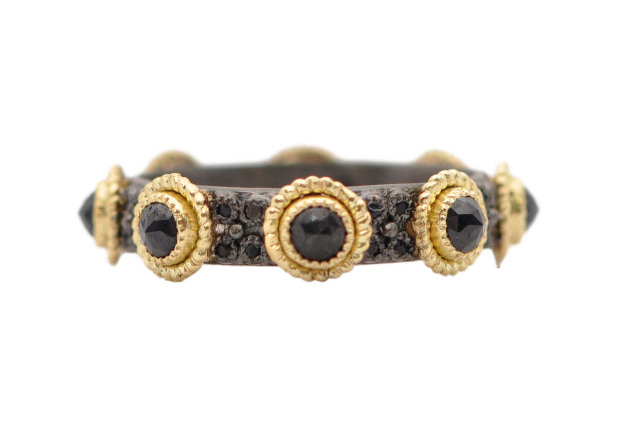 Enjoy a shimmering statement with this exquisite stack band. Crafted out of 18k yellow gold and sterling silver with blackened rhodium finish, it features a sparkling center of rose cut black sapphires and double layered 1mm round black sapphires. Perfect for everyday wear, this 3.5mm wide band is sure to make a lasting impression. BLACK SAPPHIRE ROSE CUT STACK BAND