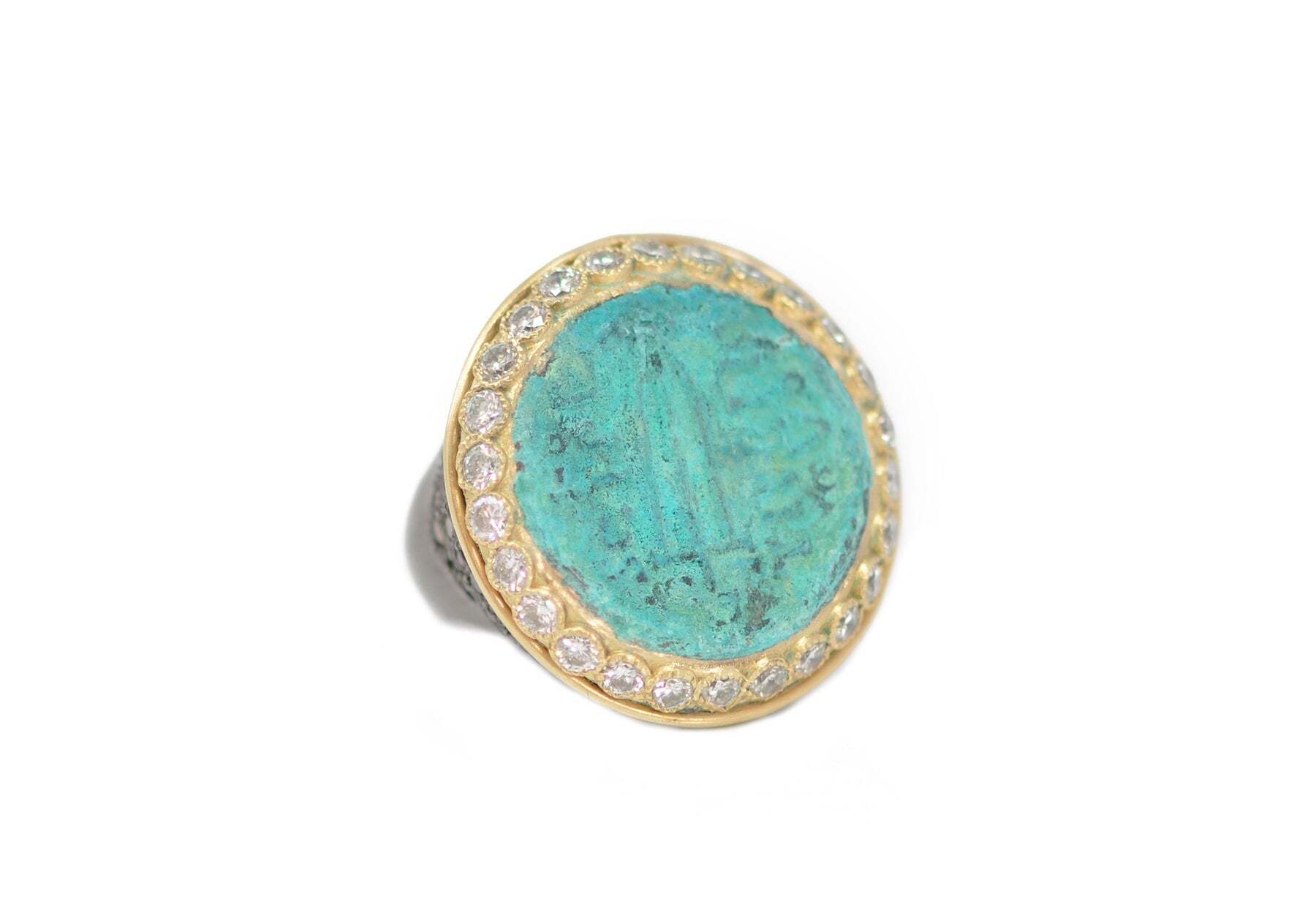 Step into luxury with this breathtaking 18K Yellow Gold and Grey Sterling Silver ring. Featuring a 26mm artifact medallion signet ring in a Turquoise patina, this accessory is sure to draw attention. An exquisite champagne and white diamond combination adds a touch of elegance, making this a perfect piece for any jewelry collection. Whether you are looking for a special occasion piece or just a stunning addition to your wardrobe, this 18K Yellow Gold and Grey Sterling Silver Ring with 26mm artifact medallion is sure to make a statement. Artifact Signet Ring