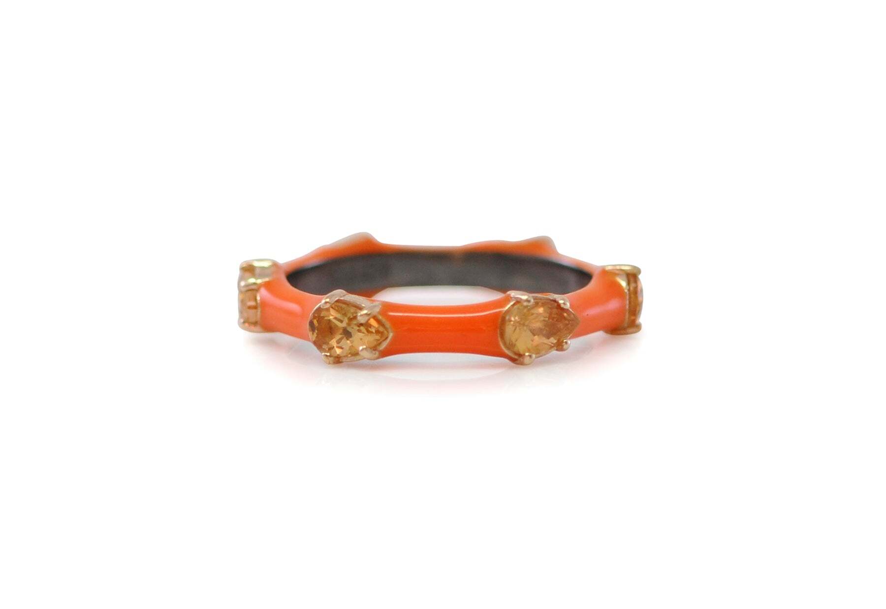 This stunning stack band ring features a unique design of 14k rose gold and blackened sterling silver for an eye-catching contrast. At the center of the ring is a stunning pear-shaped peach Imperial topaz, encircled by a bright and vibrant Tuscan orange enamel. Perfect for wearing alone as a statement piece, or mixing and matching with other rings, this ring adds a sophisticated and eye-catching touch to any ensemble. Enamel with Pear Peach Imperial Topaz Stack Ring