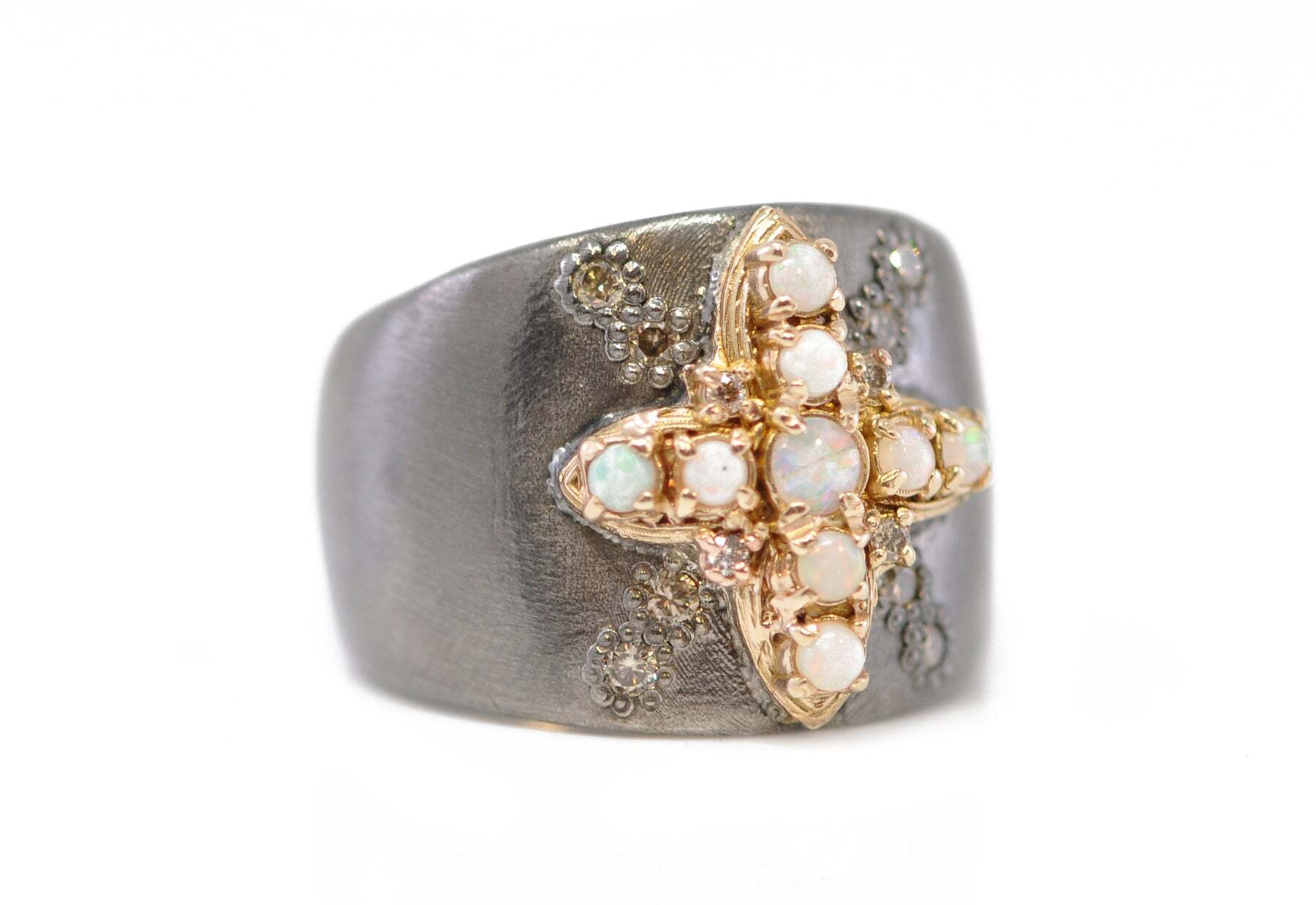 This unique statement ring is crafted from the finest 14k rose gold and sterling silver. It features a cross design inlaid with shimmering 0.19 carats of exquisite champagne diamonds and brilliant white opals. The sleek and timeless design of this ring make it a perfect choice for any special occasion. Whether you're looking to add a touch of sophistication to your everyday wardrobe or you're searching for the perfect piece to express your faith, this rose gold and sterling silver cross ring is sure to be a treasured addition to your jewelry collection. WHITE OPAL CROSS STATEMENT RING