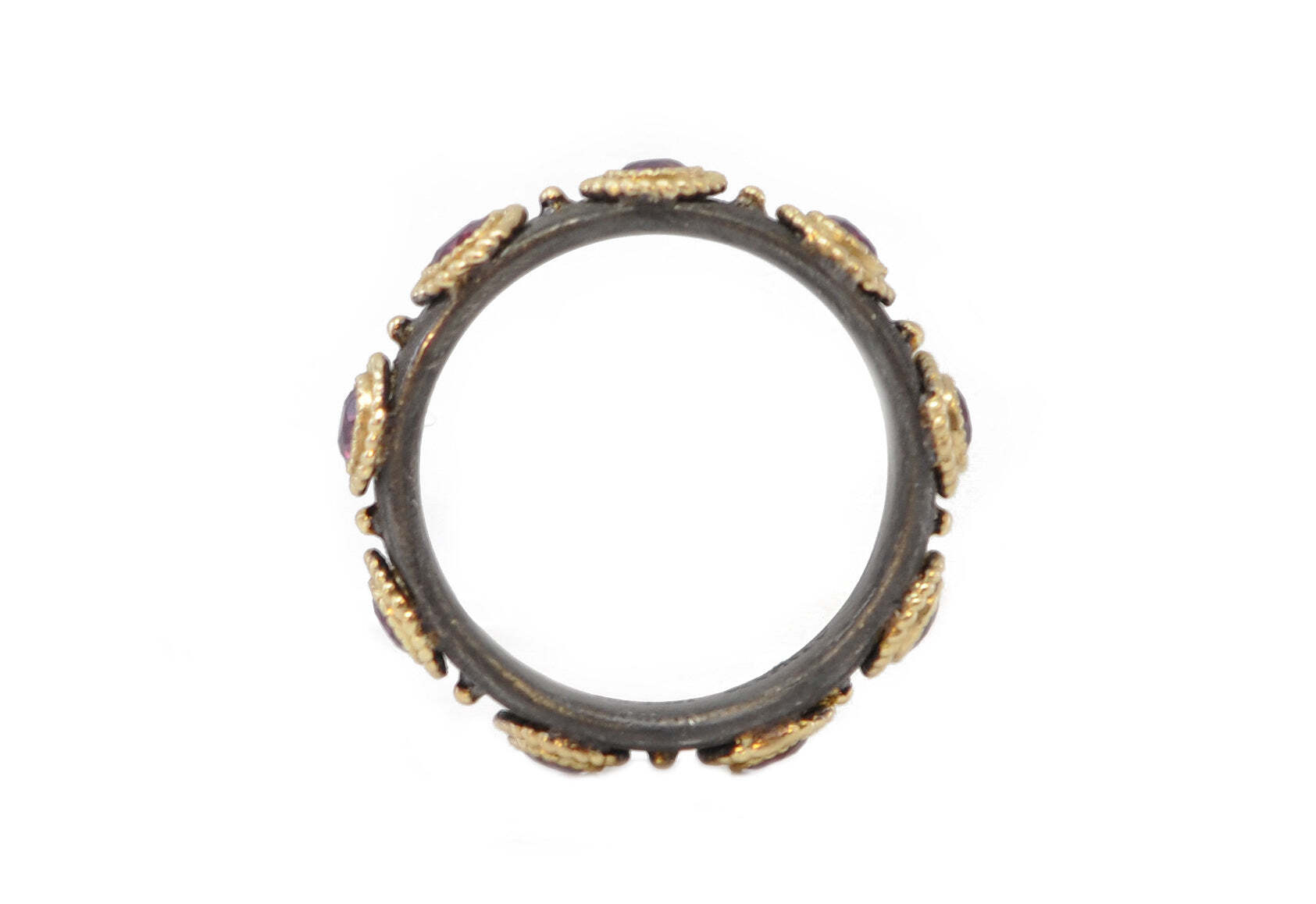 Introducing this stunning 18k Yellow Gold and Blackened Sterling Silver Ring, featuring 3 alluring 3mm Purple Garnets, creating a striking jewelry piece that won't go unnoticed. The beautiful contrast of the yellow gold and darkening silver is a sophisticated look that has been meticulously crafted for a stunning display of style and elegance. Perfect for any special occasion, this dazzling ring will be cherished for years to come. PURPLE GARNET STACK BAND RING