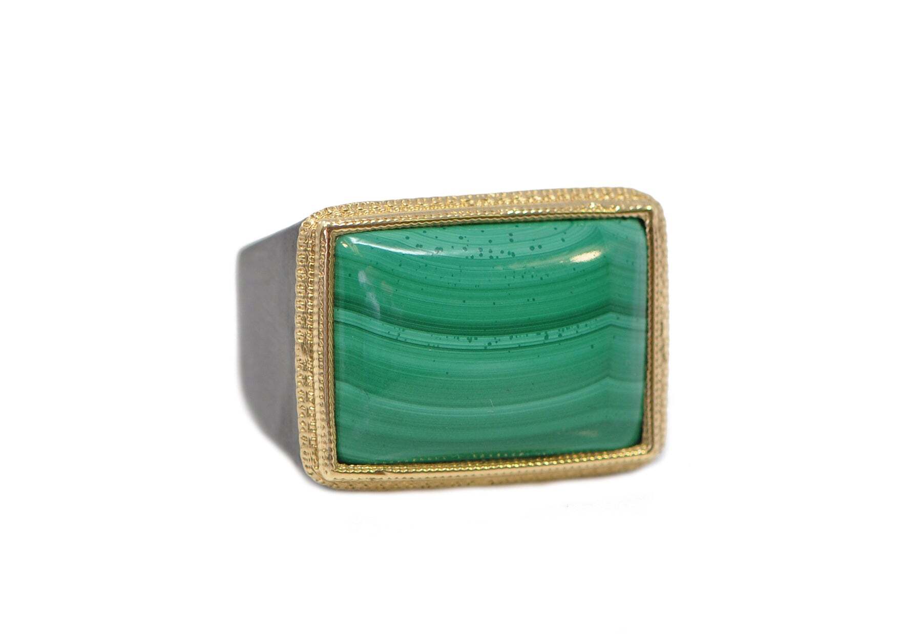 This stunning men's cocktail ring is truly one-of-a-kind. Crafted with 18k yellow gold and grey sterling silver, the unique design is accented perfectly by a 22x16 malachite cabochon. The mesmerizing green hue of the malachite cabochon is sure to turn heads and make a lasting impression. This luxurious and eye-catching ring is a must-have for any jewelry collection. MALACHITE CABACHON COCKTAIL RING