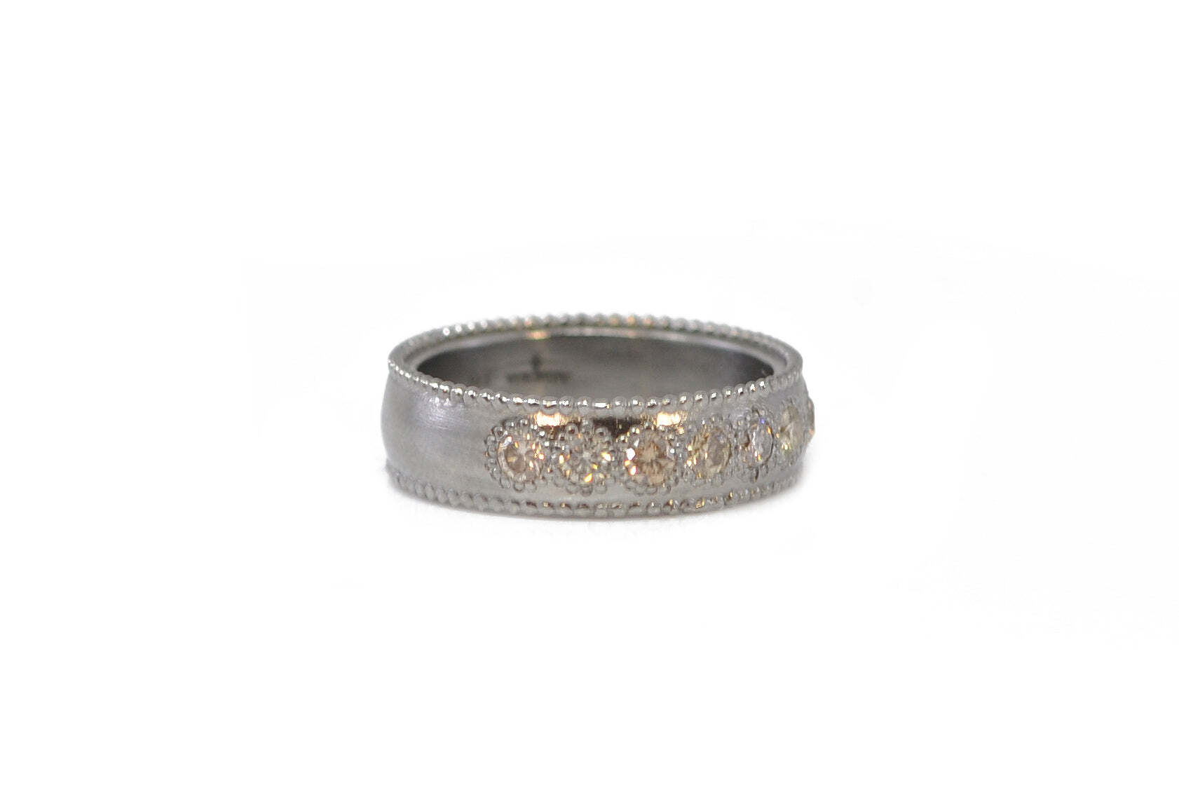 This beautiful sterling silver ring is adorned with sparkling champagne diamonds that are sure to take your breath away. The grey finish of the sterling silver gives this ring a unique and eye catching look. The 2.5mm stones are 0.76 carats, making this the perfect piece of jewelry to give as a special gift or to treat yourself. With this ring, you can be sure to make a bold statement. DIAMOND STACK RING