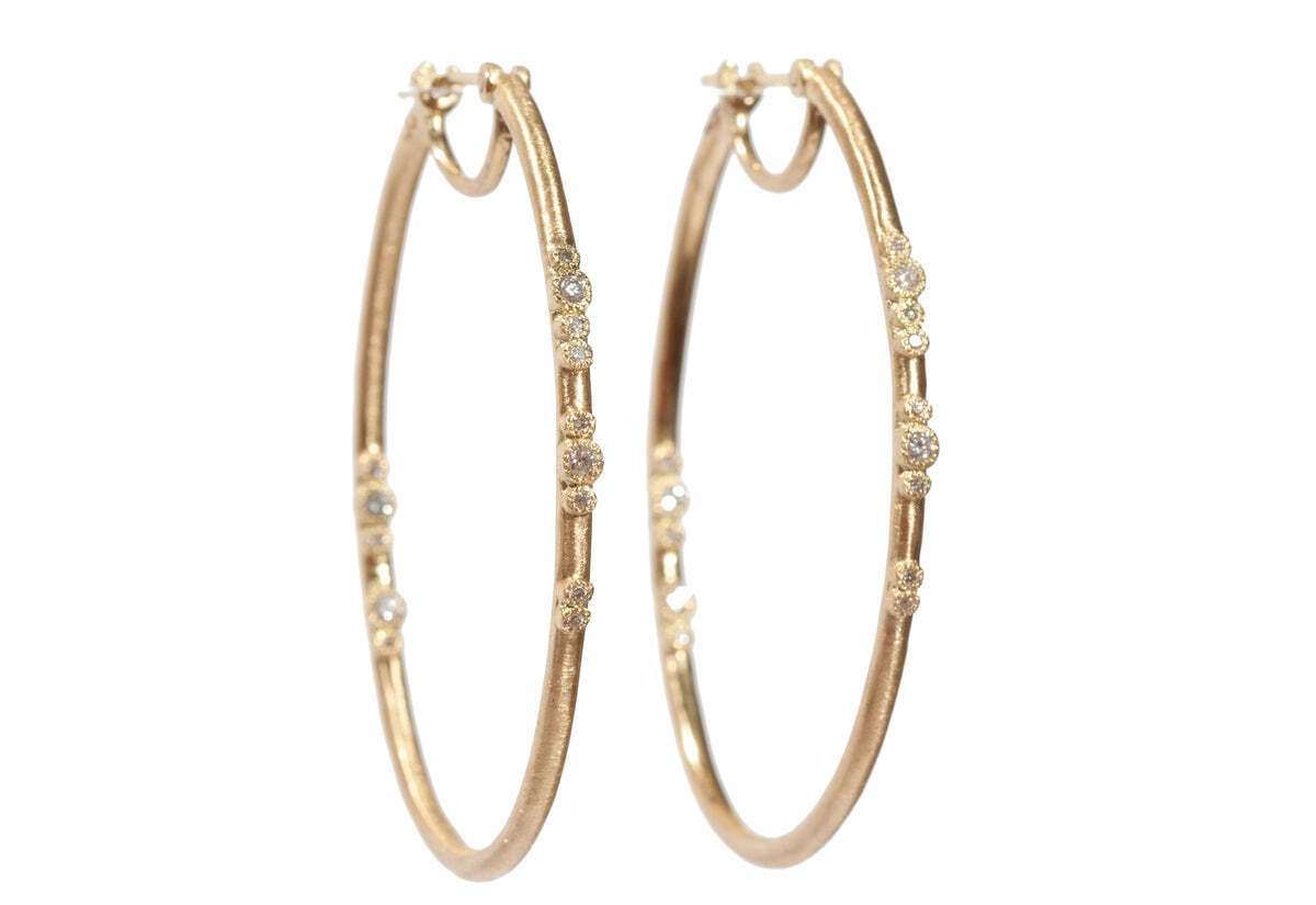 Turn heads with these sophisticated 18K Yellow Gold Side Eternity Elongated Scattered White Diamond Hoop Earrings. Perfect for special occasions or for everyday wear, these earrings are sure to become staples in your jewelry collection. Crafted from 18K yellow gold, these stunning earrings feature an elongated shape and are scattered with over 0.24 carats of twinkling white diamonds. These sparkling earrings are sure to make you feel glamorous. Oval Hoop Earrings