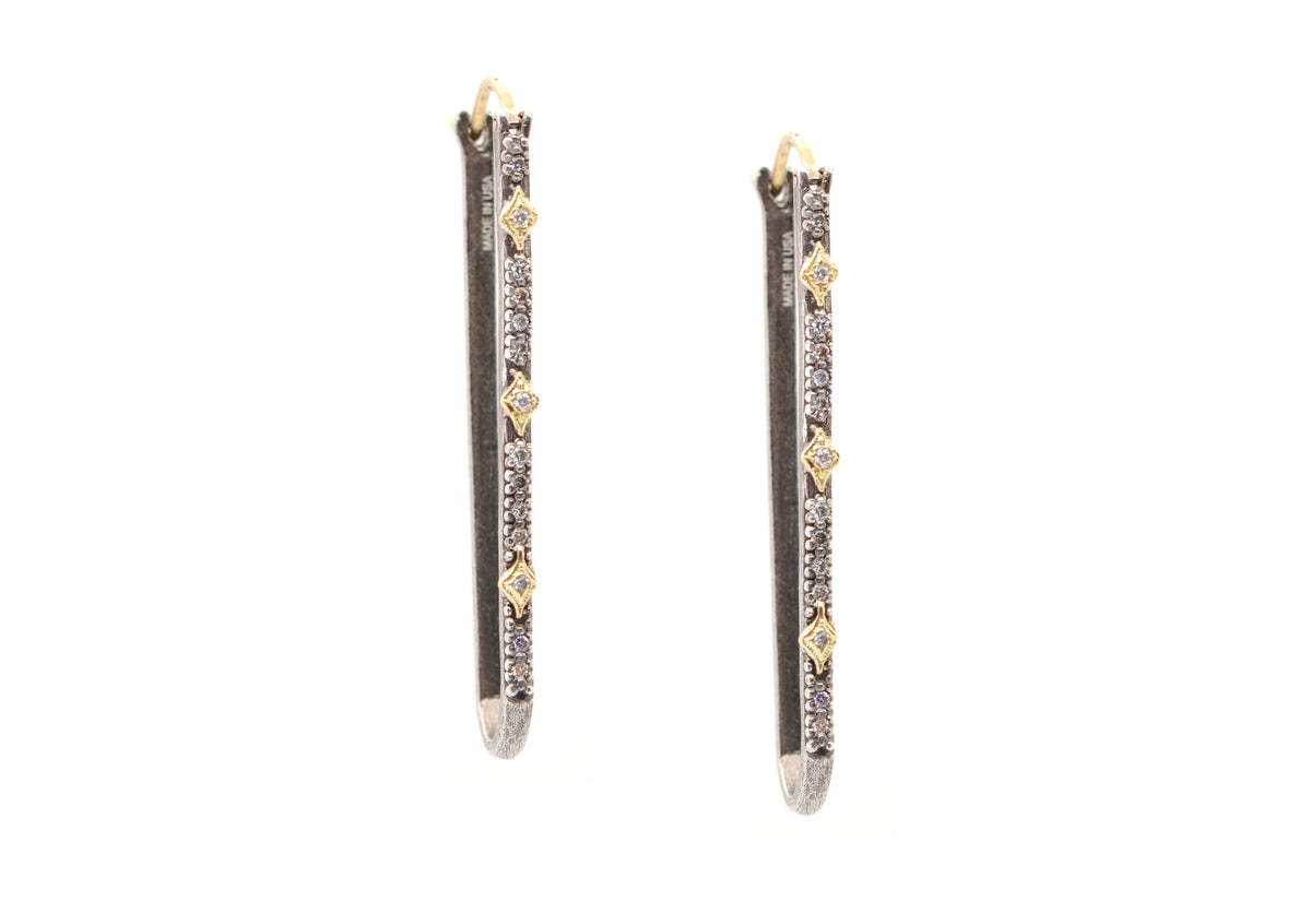 Be stylishly sophisticated with the elegant 18K Yellow Gold and Grey Sterling Silver 40MM Paperclip Crivelli Earrings with White and Champagne Diamonds. These modern earrings feature an impressive 0.15 carat total weight of diamonds, with sparkling white and champagne colored stones creating an eye-catching contrast with the grey sterling silver and luxurious 18K yellow gold. Ideal for any occasion, these unique earrings add a touch of glamour to your look. Paperclip Earrings