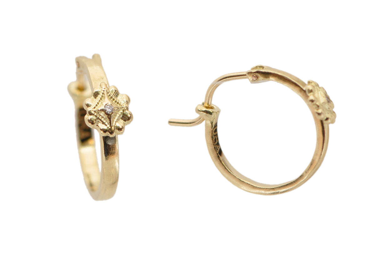 Adorn yourself in style with these stunning 18k Yellow Gold 13mm Floral Huggie Earrings featuring White Diamonds. The classic design of these earrings feature a beautiful diamond-encrusted floral pattern, adding sparkle and sophistication to any ensemble. The gold hoop hugs your earlobe, securely and comfortably, with a bold 13mm size making a statement. The diamonds are a crisp white and contrast nicely against the yellow gold metal, creating a look that is sure to turn heads. Whether you're attending a special event or just looking to add a touch of luxury to your daily outfit, these earrings are the perfect choice. 13MM FLORAL HUGGIE HOOP EARRINGS
