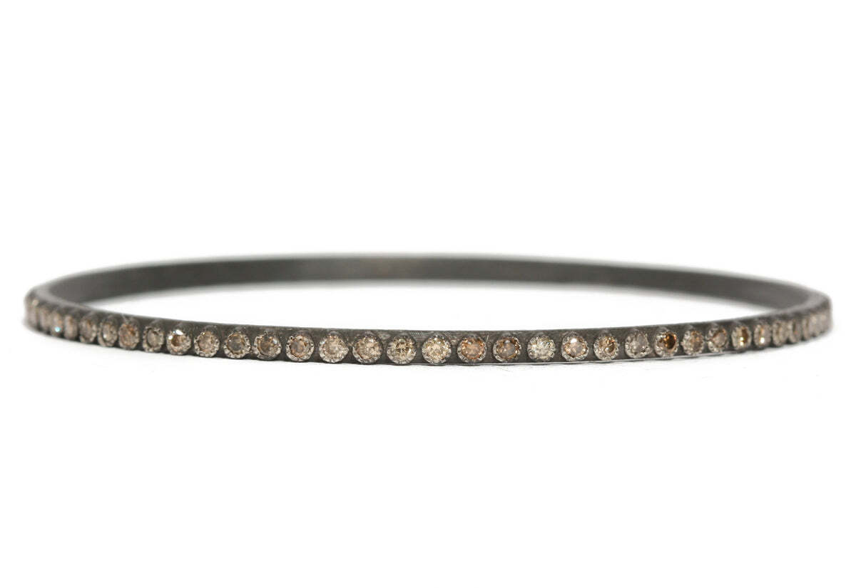 This magnificent blackened sterling silver bangle bracelet with champagne diamonds (1.84 TCW) is just dazzling! Perfect for a mother's day gift or any special occasion, this classic and elegant piece of jewelry features a polished sterling silver bangle that has been lovingly blackened to bring out the natural beauty of the diamonds. The champagne diamonds (1.84 TCW) are expertly set in an intricate and classic pave pattern, glimmering and catching the eye with every movement. With an alluring and timeless charm, this bracelet is sure to be the perfect accessory for any occasion. Classic Bangle Bracelet