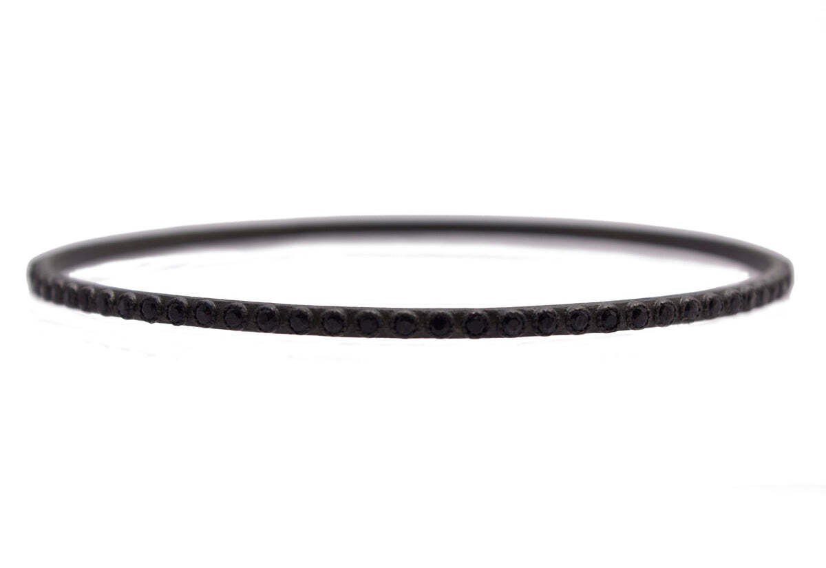 This chic Blackened Sterling Silver Bangle Bracelet is the perfect addition to any jewelry collection. The classic bracelet is blackened for a distinctive finish and is set with 2.0 carats of black diamonds for an exquisite touch of sparkle. This timeless piece of jewelry is ideal as a statement piece or layered with your other favorite bracelets. Enjoy the look of glamour and sophistication every time you wear this beautiful Blackened Sterling Silver Bangle Bracelet with Black Diamonds. Classic Bangle Bracelet