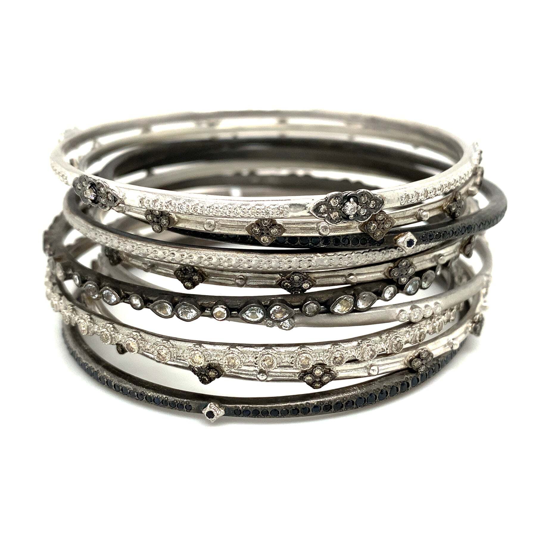 This stunning Sterling Silver and Blackened Sterling Silver Bangle Bracelet is the perfect accessory for any special occasion. A beautiful silver Crivelli design serves as the centerpiece while black sapphires offer a nice contrasting sparkle. The intricate details of the Crivelli combined with the luxurious black sapphires creates a look that is sure to turn heads. Whether you're attending a formal dinner or dinner party, this bracelet is the perfect way to add a delicate, but classic touch to any ensemble. Crivelli Bangle Bracelet
