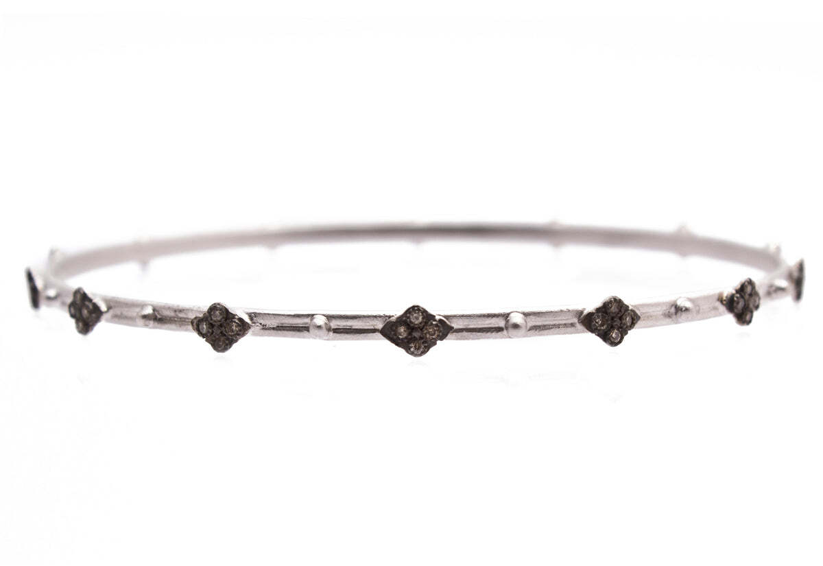 This Sterling Silver and Blackened Sterling Silver Crivelli Bangle Bracelet with Granulation and Champagne Diamonds (0.34 TCW) adds an extra special touch of elegance and sophistication to any outfit. Crafted from the finest materials and featuring .34 carats of champagne diamonds and granulated detailing, this timeless piece is sure to become your favorite for years to come. With guaranteed Christmas delivery, it's the perfect last-minute gift for the special someone in your life. Crivelli and Granulation Bangle Bracelet