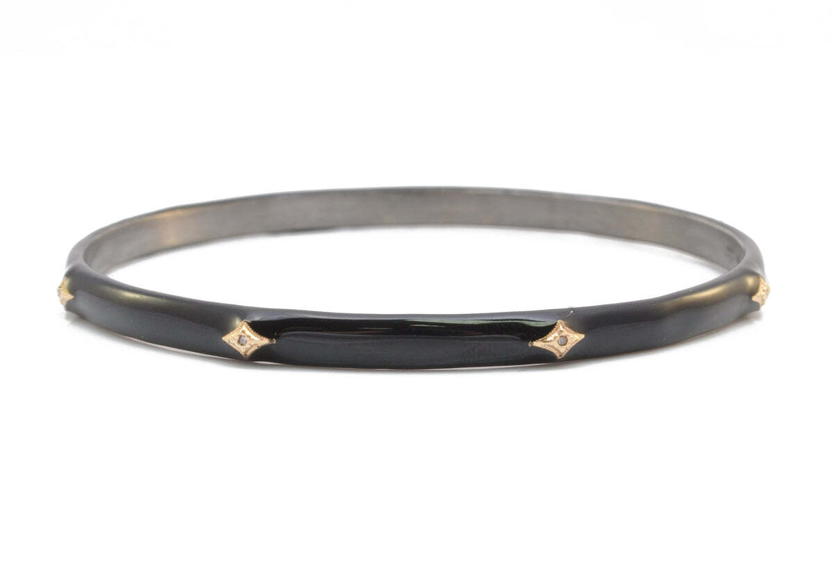 This 14K rose gold and grey sterling silver Crivelli bangle bracelet is the perfect combination of classic and modern. The sleek and contemporary black enamel finish is embellished with sparkling white diamond accents for a touch of luxury. The total carat weight of the diamonds is 0.03 TCW. This timeless bracelet will make the perfect addition to her jewelry collection. Crivelli Black Enamel Bangle Bracelet
