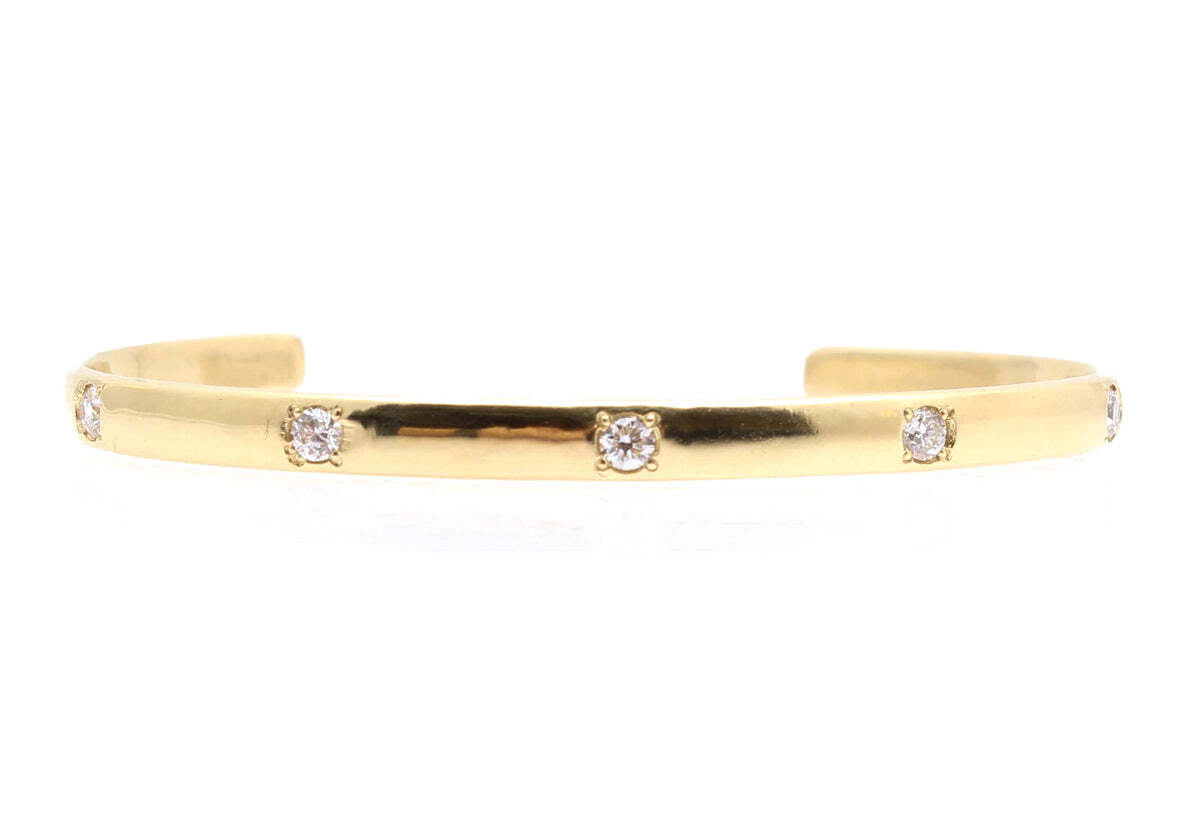 This stunning cuff bracelet is the perfect statement piece. Crafted in 18K yellow gold, it features an eye-catching design highlighted by a line of shimmering white diamonds. The bracelet measures 6 inches long and features approximately 0.55 total carats of diamonds that were hand selected for their quality and beauty. Each diamond is handset by skilled artisans in a polished setting that is sure to garner attention anytime you wear it. For a look that will make you feel beautiful, this polished diamond cuff is the perfect choice. Diamond Cuff Bracelet