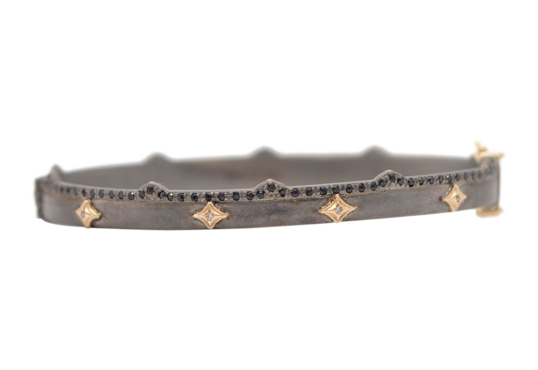 Add a touch of modern elegance and sparkle to your jewelry collection with this beautiful 14 karat rose gold and blackened rhodium finish sterling silver crivelli huggie. This piece is adorned with black sapphires and 0.02TCW champagne diamonds, adding luxurious sparkle and glamour that you can show off all day, everyday. The blackened rhodium highlights the amazing craftsmanship of the piece and is further accentuated by the amazing 6.53mm wide at the widest point and 5.42mm wide at the thinnest point of this delicate huggie. Perfect for adding a chic and stylish touch to any look, this stunning huggie will be an amazing addition to your jewelry CRIVELLI HINGED BRACELET