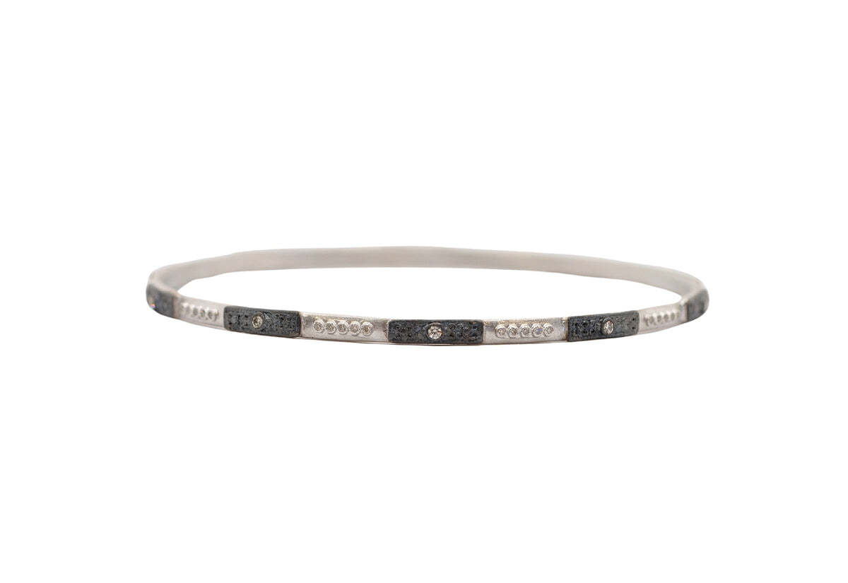 This stunning X-LARGE bangle bracelet from our Sterling Silver and Blackened Sterling Silver collection is sure to make a statement. Featuring a sleek square-motif design encrusted with exquisite champagne diamonds, this bold piece of jewelry is sure to get you noticed. Perfect to wear alone or layered with your favorite bracelets, this elegant piece of sterling silver perfection will take you from day to night with ease. Square Motif Bangle Bracelet
