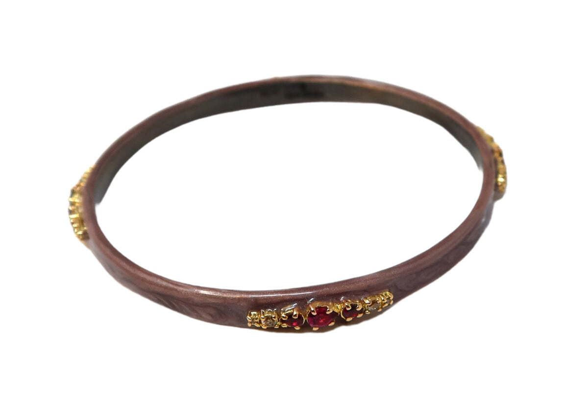 This exquisite bracelet is the perfect accessory to elevate any outfit. Featuring 14K rose gold and grey sterling silver, a seductive poetry enamel finish, a striking scroll accent, 0.29CT champagne diamonds, and a vibrant purple garnet, this one-of-a-kind piece is sure to make a statement. The combination of the soft rose gold, cool silver, eye-catching diamonds, and the vibrant pop of color from the garnet creates a timelessly elegant piece. This unique bracelet will be the crowning glory of all your looks. SEDUCTIVE POETRY ENAMEL PURPLE GARNET BANGLE BRACELET