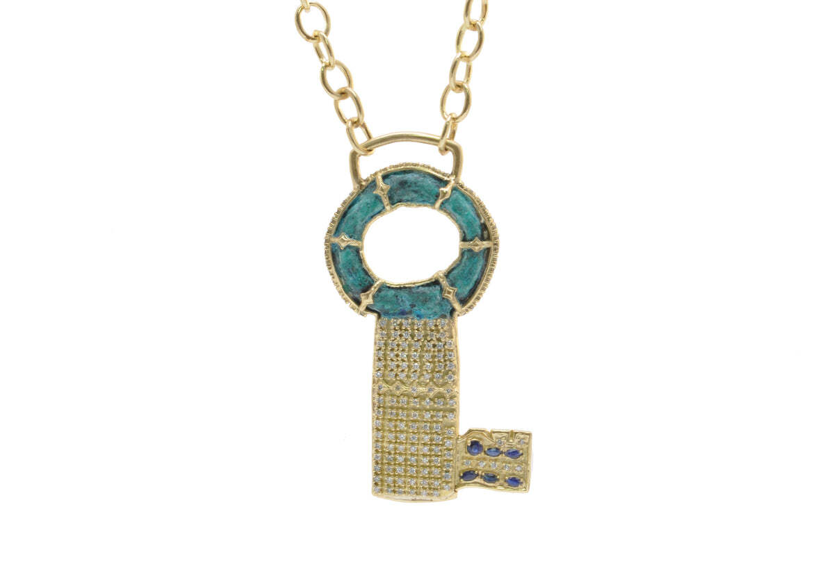Add a touch of luxury to your daily look with this beautiful 18K Yellow Gold Artifact Key Necklace. Expertly crafted in precious 18K yellow gold, it features a stunning key charm encrusted with dazzling white diamonds and a marquise blue sapphire for a subtle pop of color. This luxurious necklace is adjustable at 20" and 22", allowing you to customize the length for the perfect fit. With 0.77 total carat weight, this effortlessly luxurious necklace will make an exquisite addition to your jewelry collection. Artifact Key Necklace