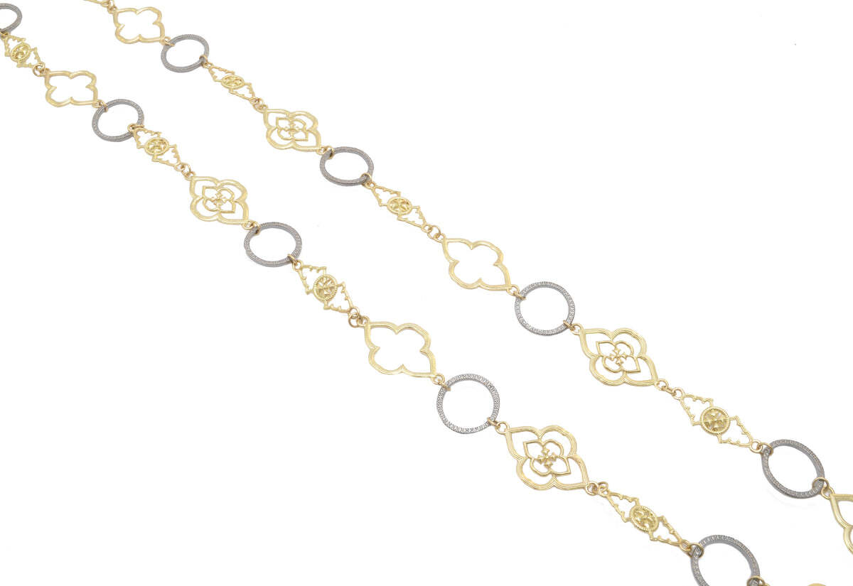 This exquisite necklace is the perfect way to add some class and sophistication to any outfit. The necklace is made from 18K yellow gold and sterling silver, with an open scroll and alternating textured ring design. The 31" necklace drapes beautifully, adding a hint of luxury to any ensemble. With its timeless and elegant look, this necklace is sure to become a favorite go-to piece of jewelry. Alternating Scroll Ring Link Necklace