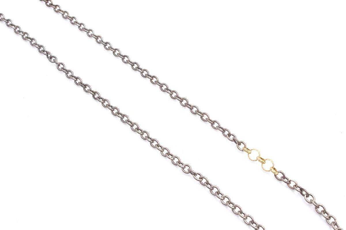 This striking necklace is designed to turn heads wherever it goes. Crafted from a combination of 18K yellow gold and blackened sterling silver, it features textured circle links, adjustable from 30" to 32". With this stunning piece, you'll be the belle of the ball! Circle Link Station Necklace