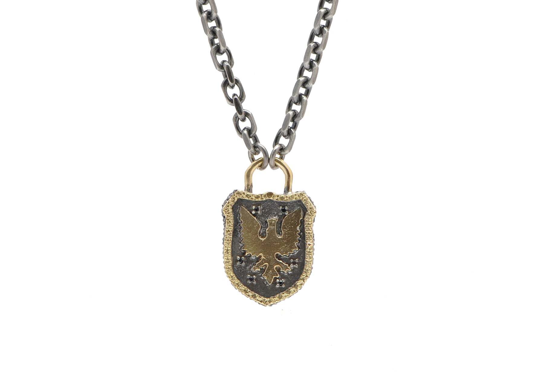 This elegant necklace will make you look sophisticated and stylish! Crafted from 18K yellow gold and grey sterling silver, this piece features a griffin shield pendant set with shimmering black sapphires. It's adjustable so you can wear it at either 22" or 24" for the perfect length for you. Whether you're dressing up for a special occasion or stepping out for a night on the town, this necklace is perfect for any occasion. Griffin Shield Necklace