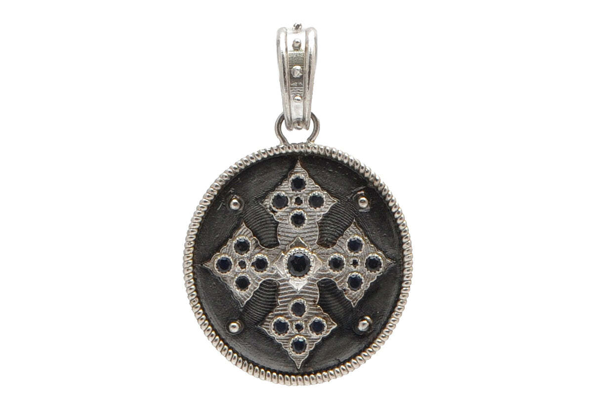 This Sterling Silver and Blackened Sterling Silver Cross Medallion Pendant with Black Sapphires is the perfect statement piece for any occasion. The beautiful and intricate sterling silver cross design is finished off with black sapphires for a touch of sophistication and luxury. The perfect way to show your faith or give a meaningful and timeless gift. This pendant will be cherished for years to come. Cross Medallion Pendant