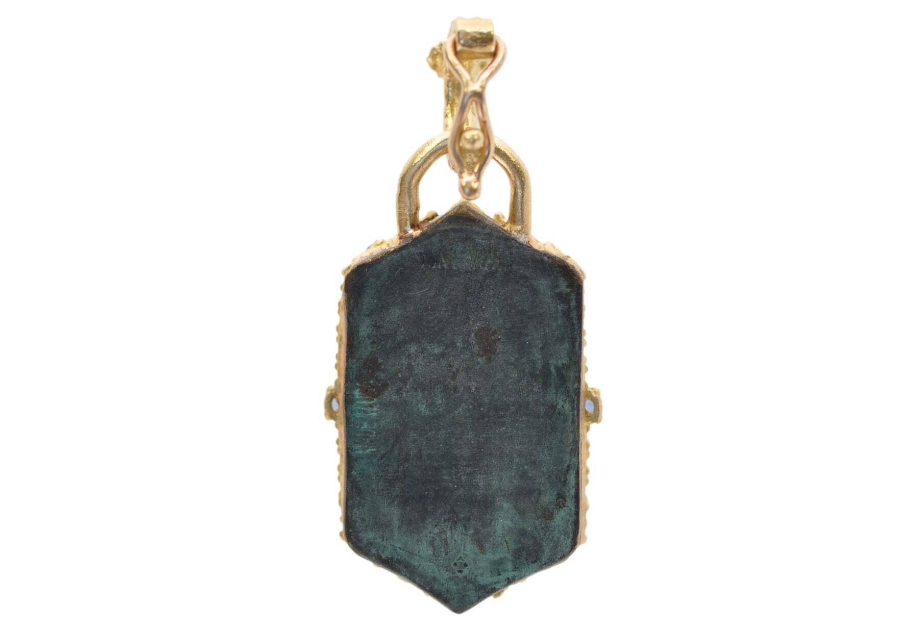 This 18k Yellow Gold Artifact Enhancer is the perfect way to add a touch of classic elegance to any jewelry collection. This stunning piece features a beautifully designed teal patina with Crivellis, blue sapphires, blue-green tourmalines, and .42TCW of round white brilliant diamonds. The enhancer measures 27mmx18mm (32mm with bail), making it the perfect addition to any necklace or pendant. Add a timeless piece to your collection with this stunning 18k Yellow Gold Artifact Enhancer. ARTIFACT SHIELD ENHANCER