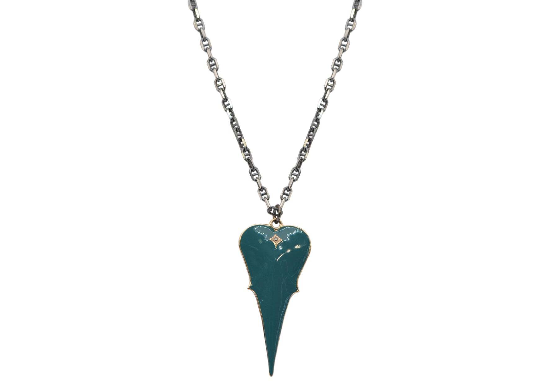 This gorgeous necklace is a unique and eye-catching piece of jewelry. The necklace is crafted from 14k rose gold and blackened rhodium finished sterling silver and features a 45mm teal enamel heart with a crivelli pattern and an astonishing 0.01TCW round champagne diamond. With an adjustable length of 16", 17" and 18" the pendant measures 47mm x 21mm. This necklace will be a beautiful statement piece that will be sure to turn heads. 18" WITH 45MM TEAL ENAMEL HEART PENDANT NECKLACE