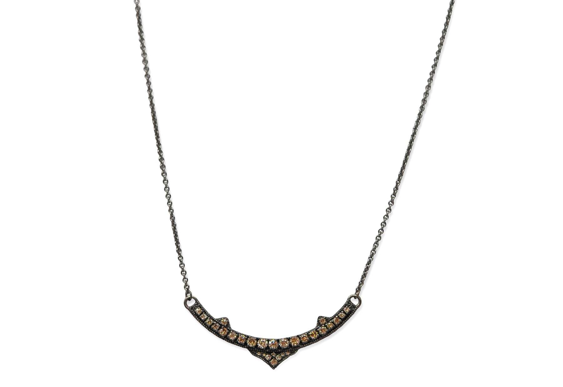 This beautiful Gunmetal Sterling Silver necklace is the perfect accessory for any outfit. The unique design features a pave pointed curved bar with champagne diamonds for a touch of sparkle. This versatile piece can be adjusted to three different lengths - 15.5", 16" and 16.5" - with a toggle closure for secure and comfortable wear. This stunning necklace is sure to make a lasting impression. Curved Bar Pendant Necklace