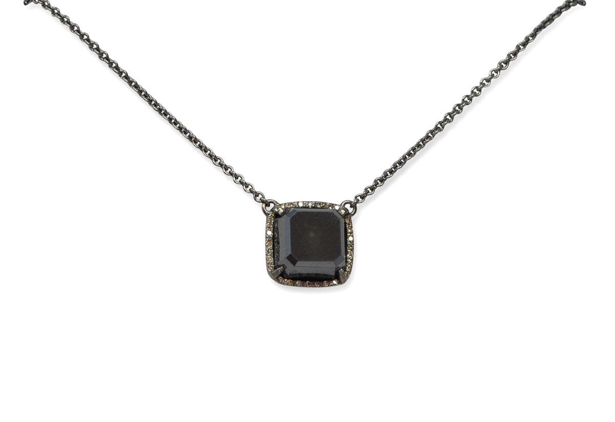 This elegant Blackened Sterling Silver 18" necklace is the perfect pairing of modern sophistication and contemporary charm. Featuring a stunning combination of hematite and white diamonds, its adjustable settings at 16", 17" and 18" easily allows you to find the perfect fit. This unique necklace sparkles and shines with effortless grace. It's the perfect piece to complete any ensemble. Hematite Pendant Necklace