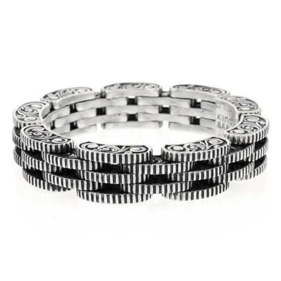 Inspired by a helicopter rotor chain, Mitchell Binder combines his love of Bulino engraving and western scroll work to embellish this handcrafted Rotor Chain Bracelet. 18 hand hammered pins make this robust bracelet fluid. A coin edge and seamless clasp add style and comfort. Rotor Link Bracelet